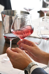 hand with glasses of red wine