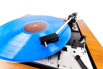 Vintage turntable with a blue vinyl isolated on white
