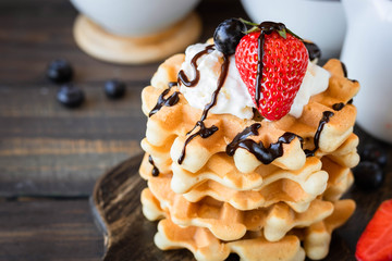 Waffles with berries and whipped cream
