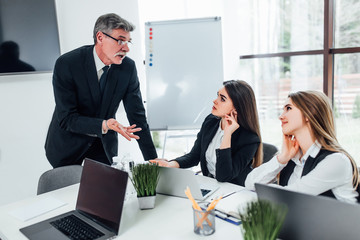 Older businessman to hide two pretty and successful woman for work in company..