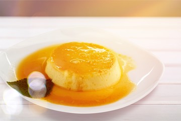 Caramel custard with cream and  topping.