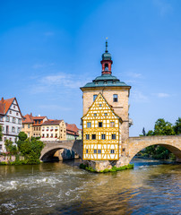 View of Old Town Hall of Bamberg (Altes Rathaus) with two bridges over the Regnitz river.