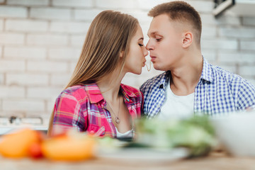 Lovely cople with spaghetti, kiss on kitchen. Romantic photo.