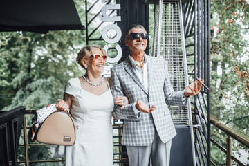 Seniors standing in the restaurant  and celebrating together beautiful time