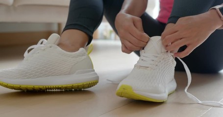 Woman wearing sport shoes at home