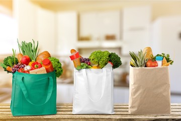 Full shopping  bags on wood tablet and window background