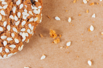 Closeup oatmeal cookies sprinkled with sesame. Background image. The concept of cooking, baking, homemade cookies. Top view, warm colors.