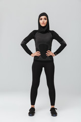Young woman fitness muslim posing isolated over white wall background.