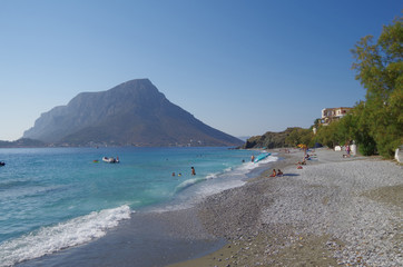 Pebble Beach Scenery on Greek Island Kalymnos with people and landscape