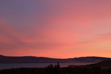 Gorgeous pink and purple sunset sky over Argentino lake in the town of El Calafate, Patagonia, Argentina