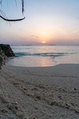 sunset view on maledives with sand in foreground