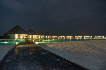 Fototapeta na wymiar water villas at the beach at night