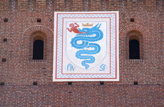 Milan, Italy: the biscione, an azure serpent in the act of consuming a human, the emblem of the House of Visconti and of the city from the 11th century, on the Filarete Tower of the Sforza Castle