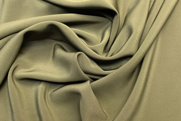 Fototapeta na wymiar Texture, background. template. Silk fabric crepe de Chine khaki in artistic layout