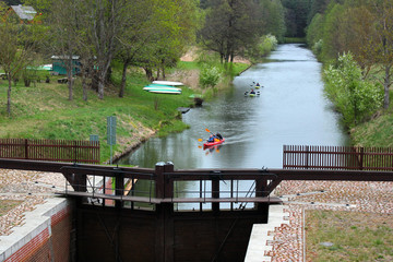 Mikaszowka, Poland - May 2, 2019: Kayakers approaching Mikaszowka Lock, the eleventh lock on the Augustow Canal in Poland, built in 1828.