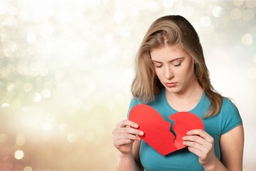 Pretty young thoughtful woman on blurred blue background