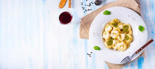 Tortellini di formaggio with basil pesto and cheese sauce