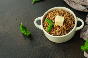 buckwheat porridge and a piece of butter (delicious food) homemade dish. food background. top