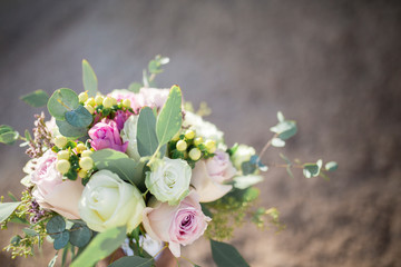 wedding bouquet with roses on sand