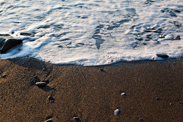 The soft ocean wave on sandy beach. Ocean wave close up with copy space for text. Background image.