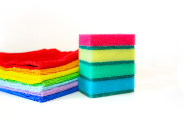 Brightly multicolored cleaning sponges and rags on white background