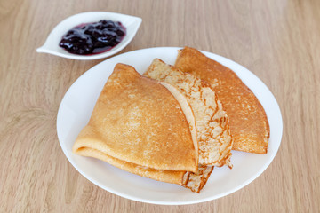 Delicious pancakes, crepes on a plate, traditional Russian dish for breakfast