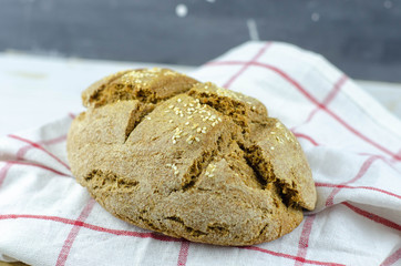 fresh rustic whole wheat bread baked at home, bio ingredients, very healthy with sesame