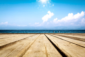 Fototapeta na wymiar Summer wooden pier of free space for your deoration and ocean landscape with sun light. 