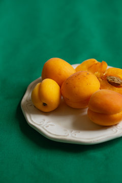 Apricots On A Plate, Dark Green Tablecloth