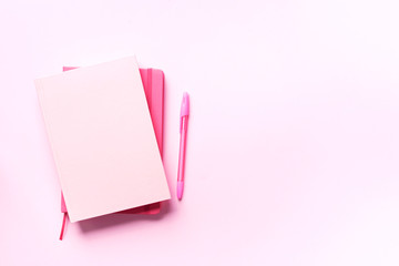 Top view of open pink notebook on pastel colorful background. Copy space. Woman business, study, back to school concept. Time managenet, to do list