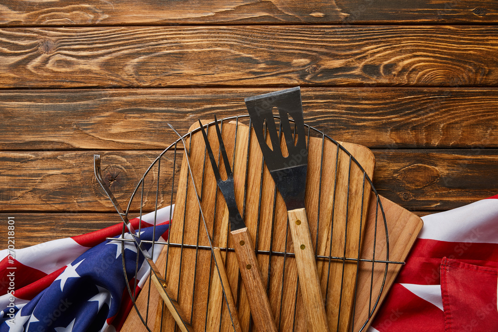 Sticker top view of american flag and bbq equipment on wooden rustic table