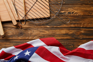 top view of american flag and bbq equipment on wooden rustic table with copy space