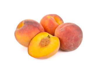 whole and half cut ripe peach on white background