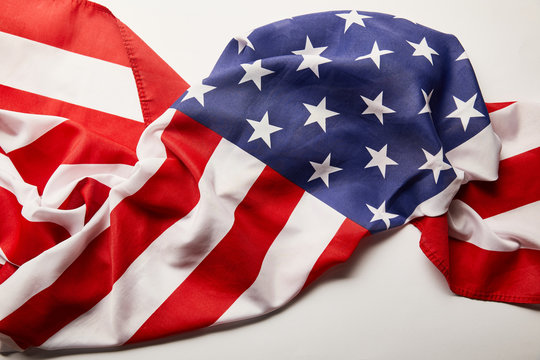 top view of crumpled national american flag on white background