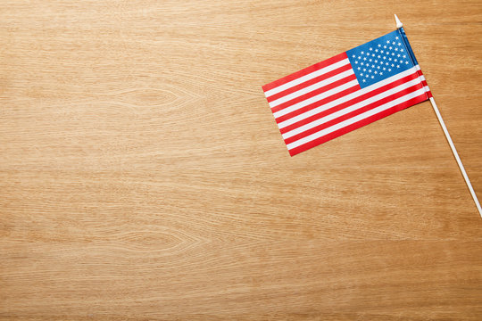 top view of american flag on wooden light table with copy space