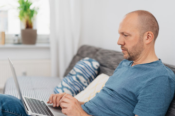 Man working on a laptop computer at home