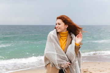 Lovely young redhead woman wearing autumn coat