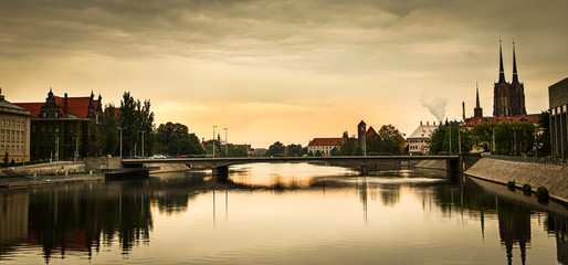 Fototapeta na wymiar View of St. John the Baptist cathedral and other historic buildings in old town Wroclaw from Oder (Odra) river