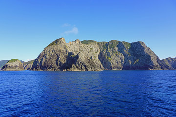 Fototapeta na wymiar Landscape view from the water in the Bay of Islands on the North Island in New Zealand