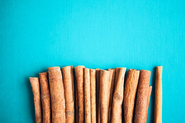 Set of cinnamon sticks on turquois background