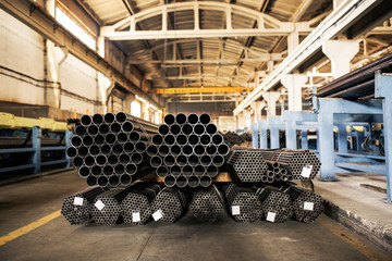 Metalic pipes on warehouse, rows of metal pipes on industrial warehouse. Industrial interior,