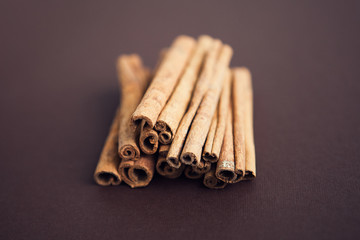 Set of cinnamon sticks on brown background
