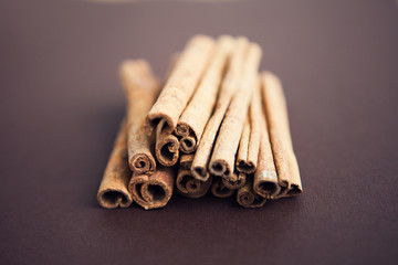 Set of cinnamon sticks on brown background