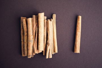 Set of cinnamon sticks on brown background