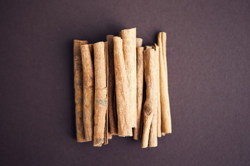 Set of cinnamon sticks on brown background