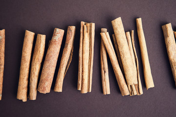 Set of cinnamon sticks on brown background