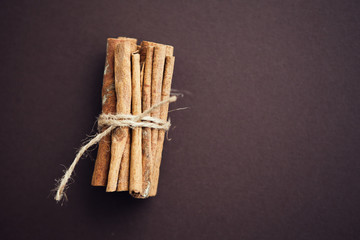 Set of cinnamon sticks on brown background
