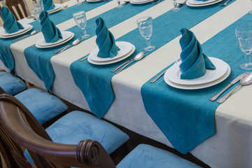 serving banquet table in a luxurious restaurant in turquoise and white style