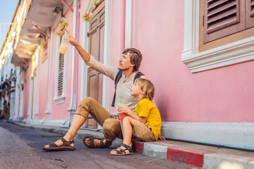 Dad and son tourists on the Street in the Portugese style Romani in Phuket Town. Also called...