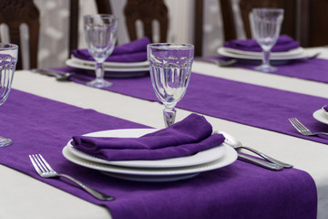 serving banquet table in a luxurious restaurant in purple and white style